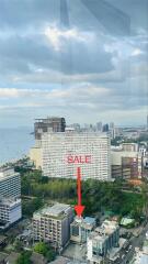 Cityscape view with buildings and sale sign