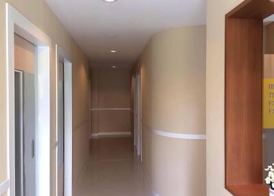 Hallway with beige walls and white accents