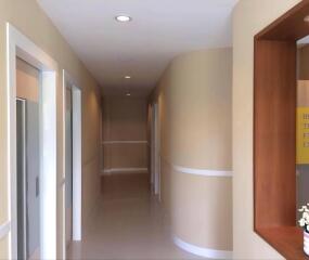 Hallway with beige walls and white accents