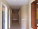 Hallway with beige walls and white accents