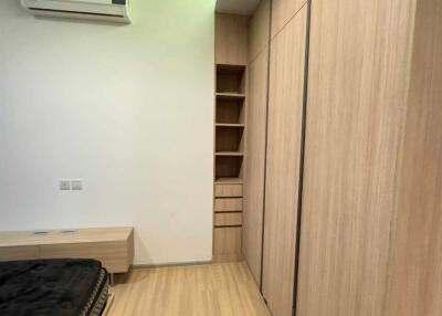 Modern bedroom with wooden closet and air conditioner