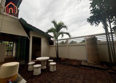 Outdoor seating area with table, chairs, and garden