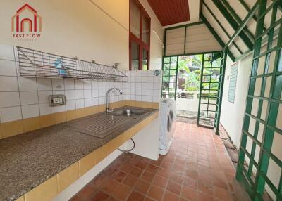 Modern kitchen with large windows, a sink, and a washing machine