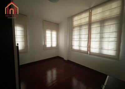 dimly lit unfurnished bedroom with wooden flooring