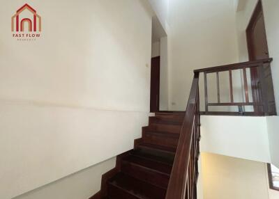 Staircase leading to upper floor with wooden steps and railings