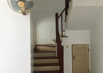 Staircase area with wall-mounted fan