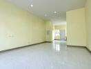 Spacious living area with tiled flooring and recessed lighting