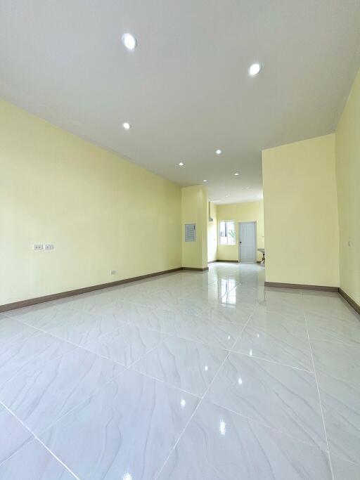 Spacious living area with tiled flooring and recessed lighting