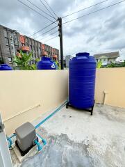 Outdoor area with water tank and utility connections