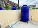 Outdoor area with water tank and utility connections