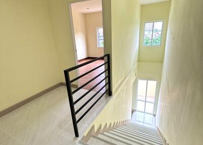 Interior staircase leading to upper floor with railings