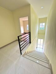 Interior staircase leading to upper floor with railings