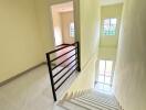 Interior staircase leading to upper floor with railings