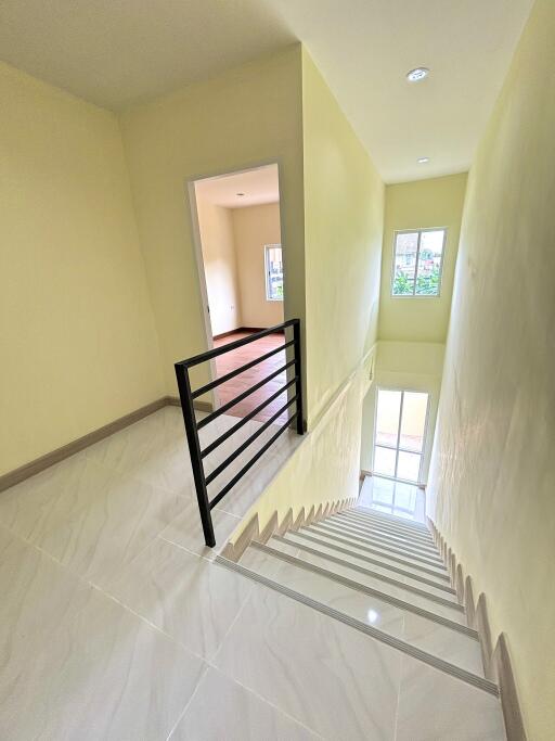 Interior staircase leading to upper floor with railings