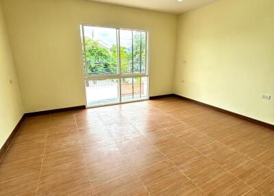 Empty room with large window and tiled floor