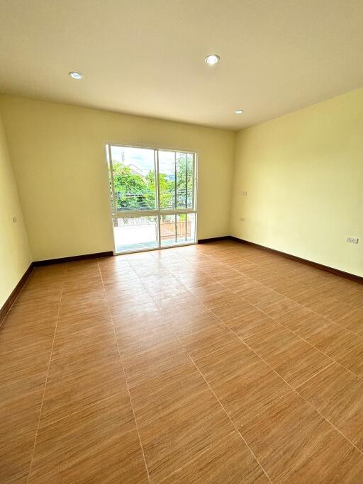 Empty room with large window and tiled floor