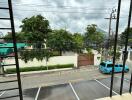 View from balcony overlooking street and parking area