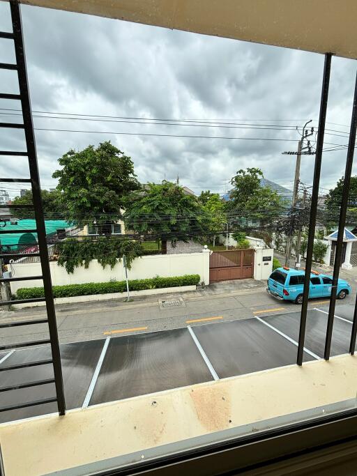 View from balcony overlooking street and parking area