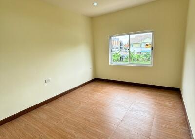 Spacious empty bedroom with wooden flooring and LED ceiling lights