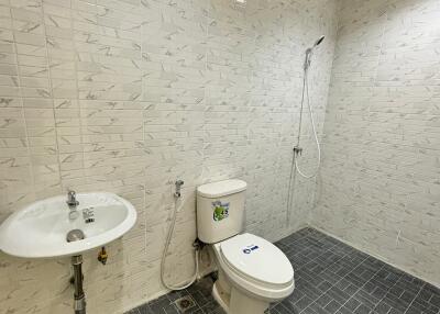 Modern bathroom with sink, toilet, and shower