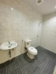 Modern bathroom with sink, toilet, and shower