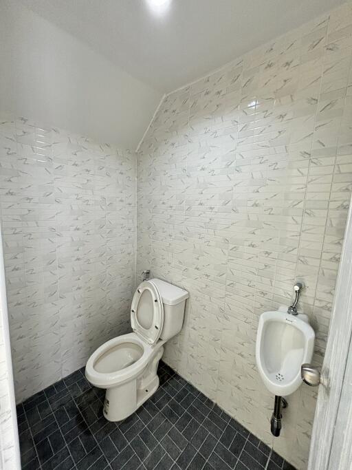 Bathroom with toilet and urinal