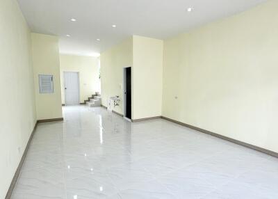 Living room with white tile flooring and recessed lighting