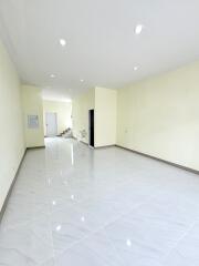 Living room with white tile flooring and recessed lighting