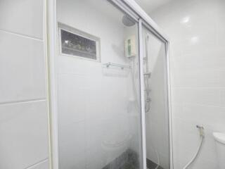 Bathroom with a glass shower enclosure and toiletries