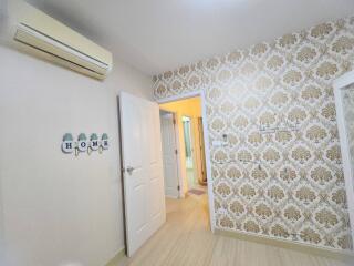 Bedroom with decorative wallpaper and air conditioning unit