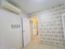 Bedroom with decorative wallpaper and air conditioning unit