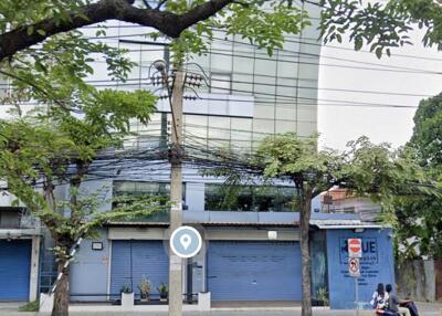 Exterior view of a building with blue doors and street view