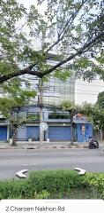 Exterior view of a building with blue doors and street view