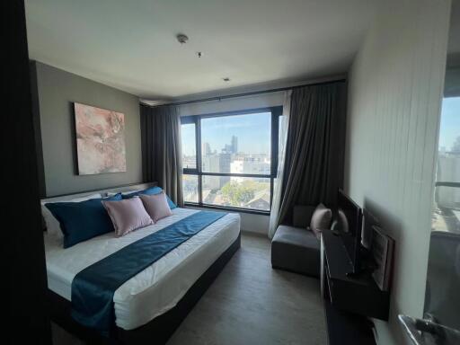 Modern bedroom with large window and city view