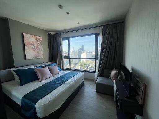 Modern bedroom with large window and city view