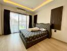 Modern bedroom with double bed and large windows