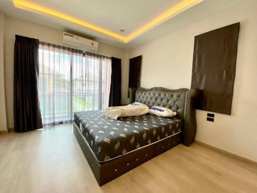 Modern bedroom with double bed and large windows