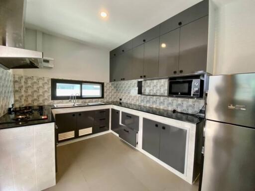 Modern kitchen with sleek cabinetry and appliances