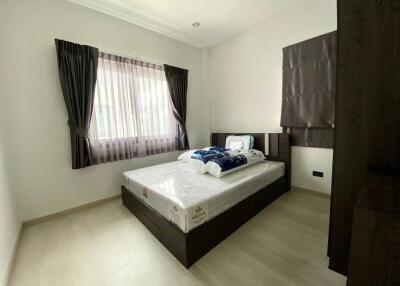 Well-lit bedroom with a window and modern bed