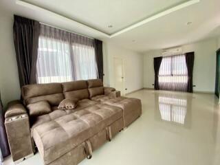 Spacious and bright living room with large windows and comfortable sectional sofa