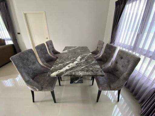 Dining area with marble table and upholstered chairs