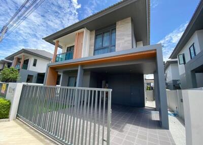 Modern two-story house exterior with garage and gate