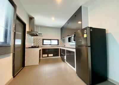 Modern kitchen with black and white cabinetry and stainless steel appliances