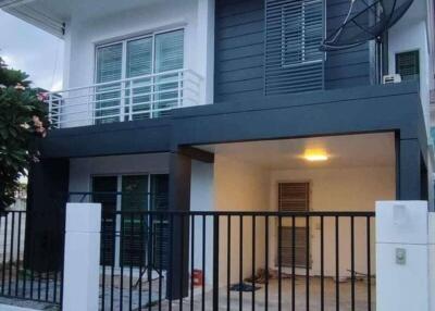 Front view of a modern two-story house with a gate