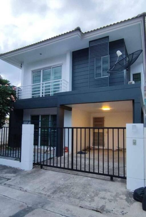 Modern two-story house with gated parking area