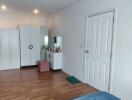 Spacious bedroom with wardrobes and dressing table