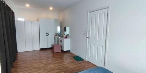 Spacious bedroom with wardrobes and dressing table