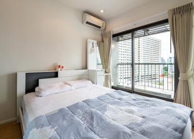 Modern bedroom with large window and balcony view