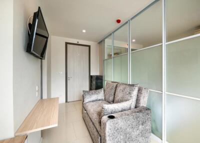 Modern living room with grey sofa and wall-mounted TV