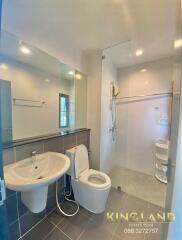 Modern bathroom with sink, toilet, and shower area